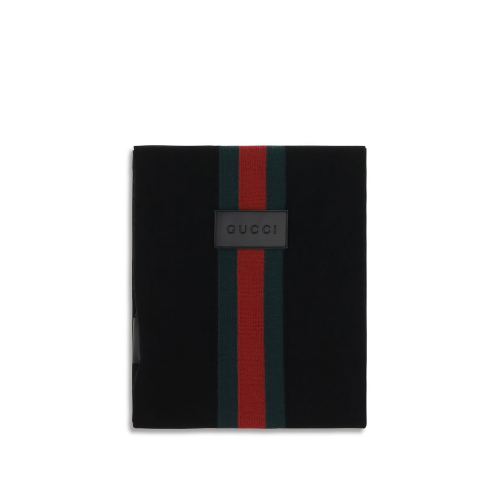 Experience the allure of the Gucci Black Wool Oves Aries Scarf, crafted from luxurious Merino wool, embodying timeless elegance and sophisticated style for discerning individuals.