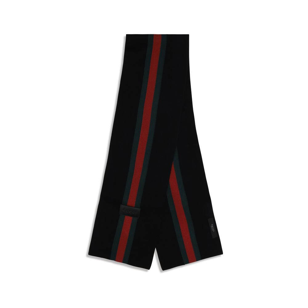 Experience the allure of the Gucci Black Wool Oves Aries Scarf, crafted from luxurious Merino wool, embodying timeless elegance and sophistication for discerning tastes.