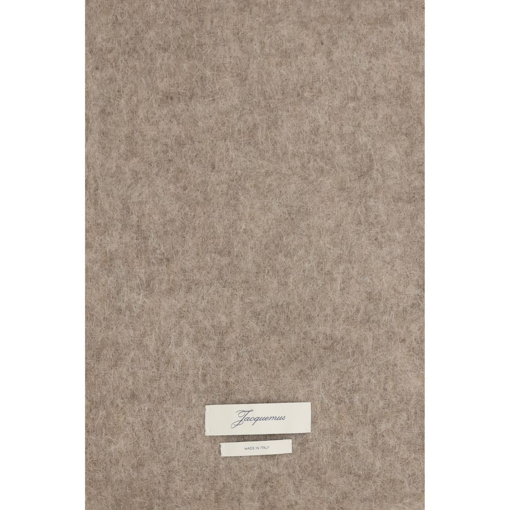 Indulge in the elegance of the Jacquemus Beige Mohair Scarf, a luxurious blend of mohair and alpaca, perfect for elevating your style with timeless sophistication.