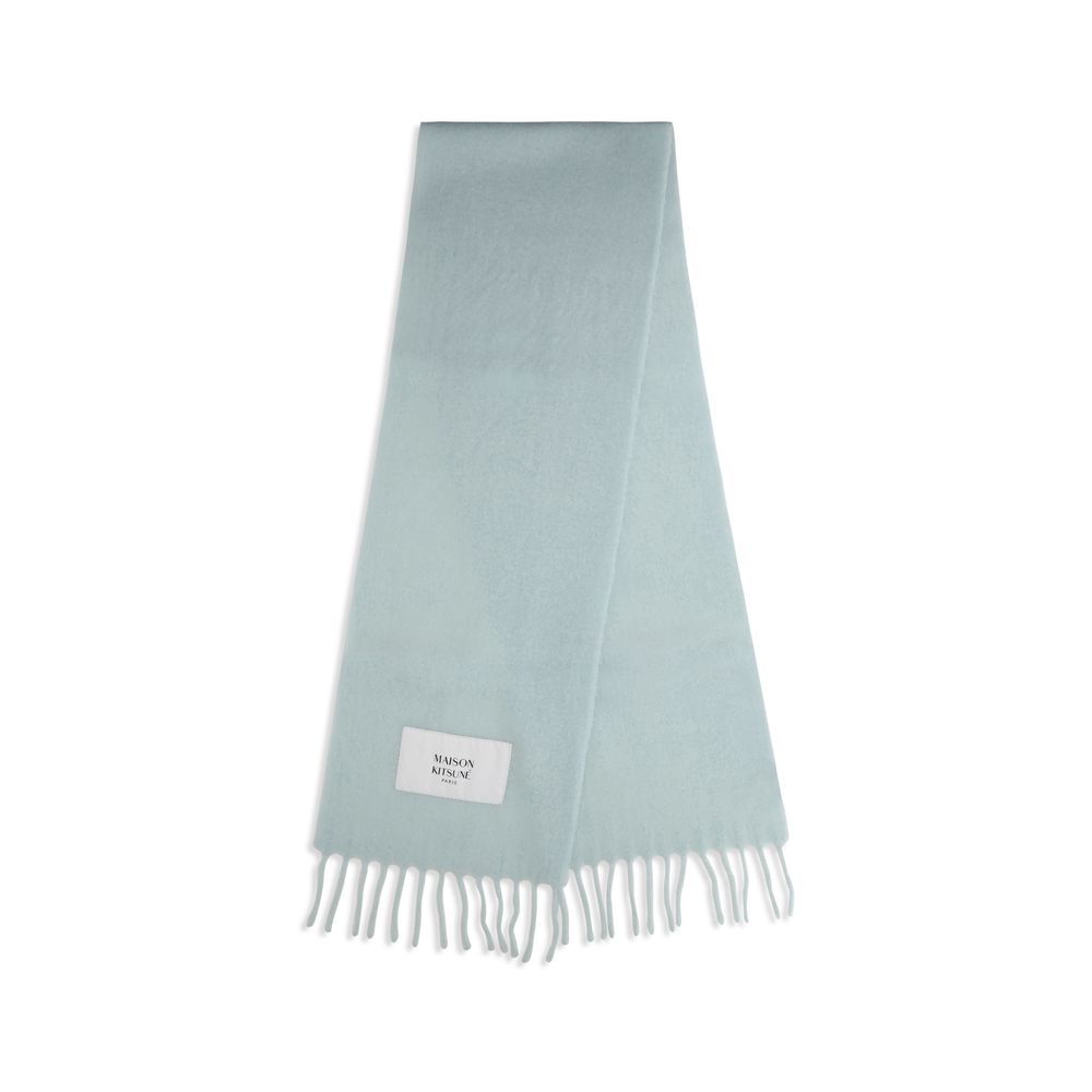 Experience the exquisite Maison Kitsuné Blue Polyamide Scarf, a luxurious blend of alpaca and polyamide, elevating your winter wardrobe with timeless elegance and warmth.