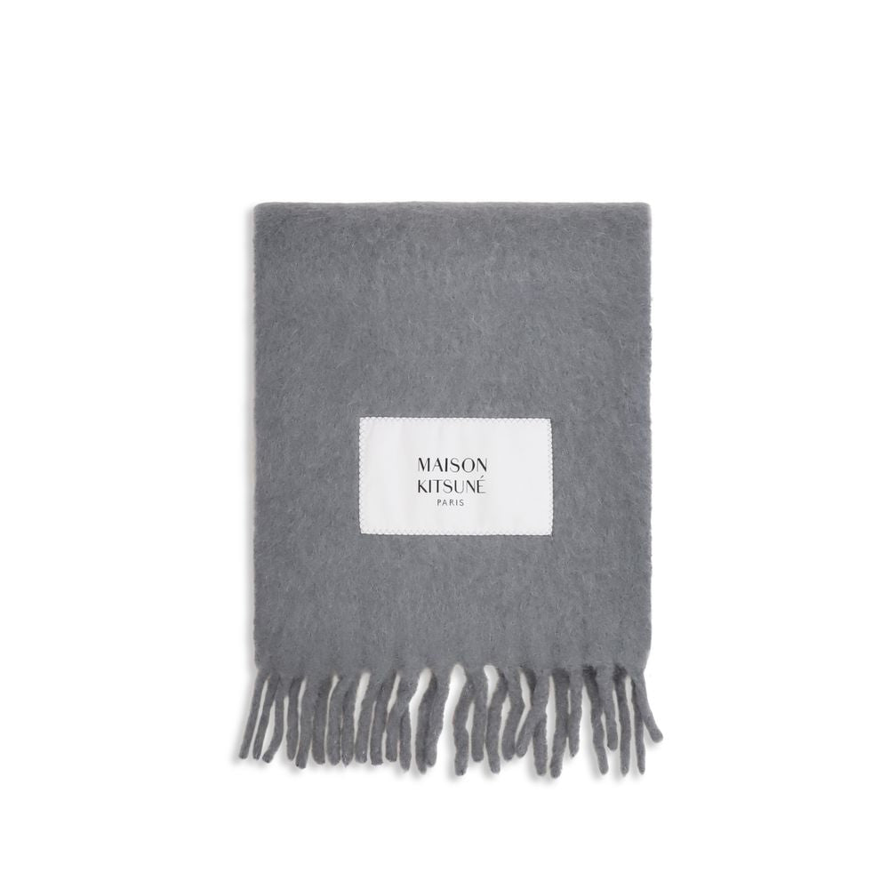 Experience the epitome of luxury with the Maison Kitsuné Gray Alpaca Vicugna Pacos Scarf, a masterpiece of softness and sophistication, perfect for any elegant wardrobe.
