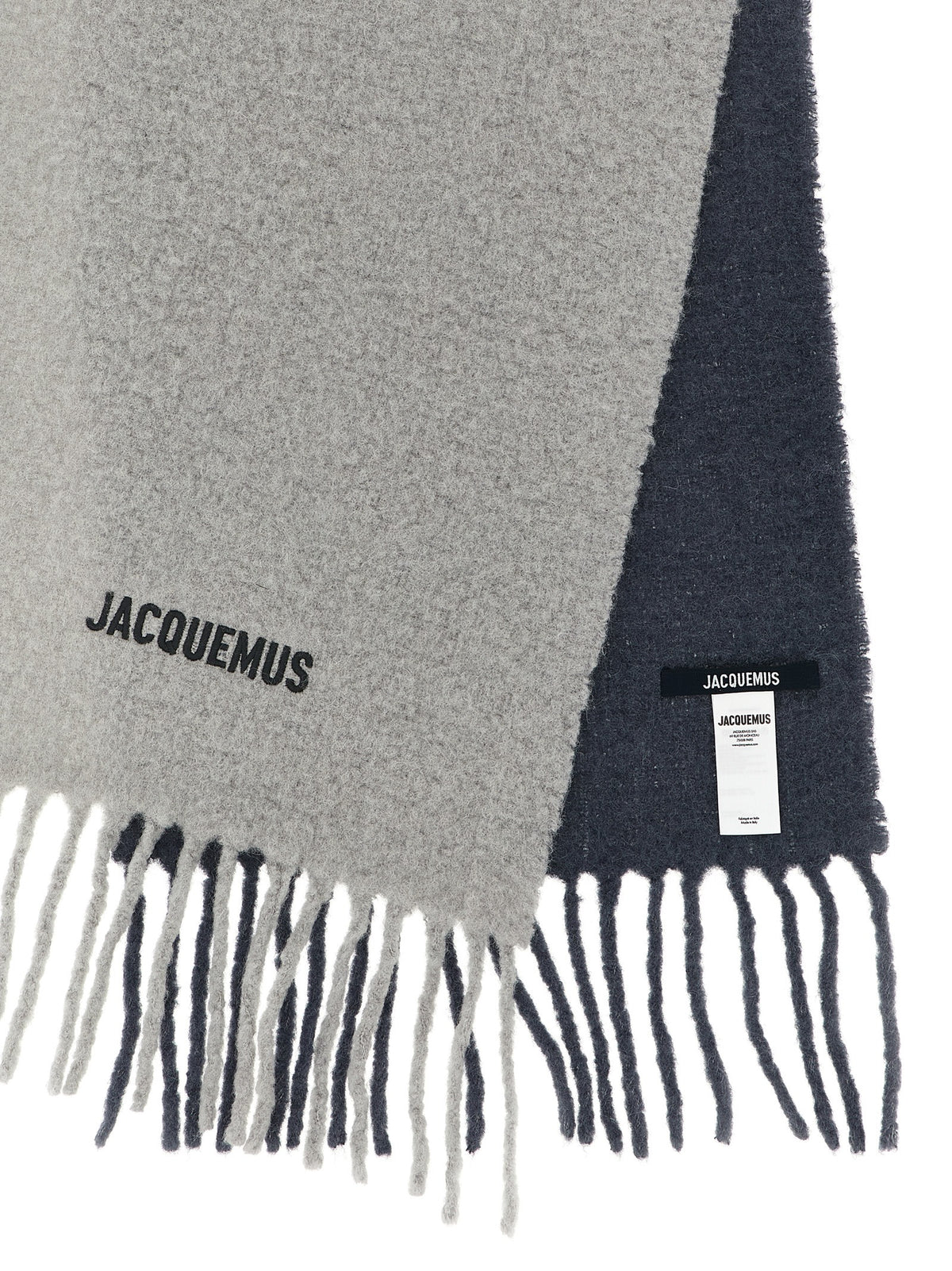 Experience the allure of the Jacquemus Gray Wool Scarf, crafted from premium degradé alpaca wool, embodying timeless elegance and sophistication for the discerning individual.