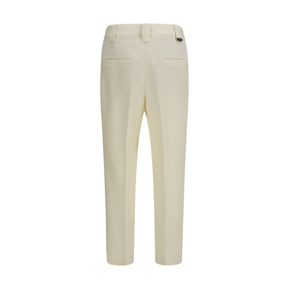 Elevate your wardrobe with Versace's Beige Wool Oves Aries Cropped Pants, a masterpiece of Italian craftsmanship, blending luxury and sophistication for the discerning individual.