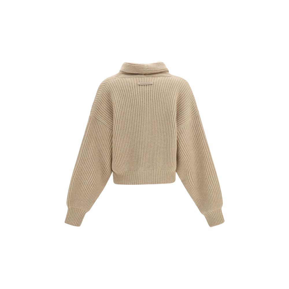Indulge in the refined elegance of the Tory Burch Beige Wool Oves Aries Cardigan, a luxurious merino wool piece that embodies sophistication and timeless style.