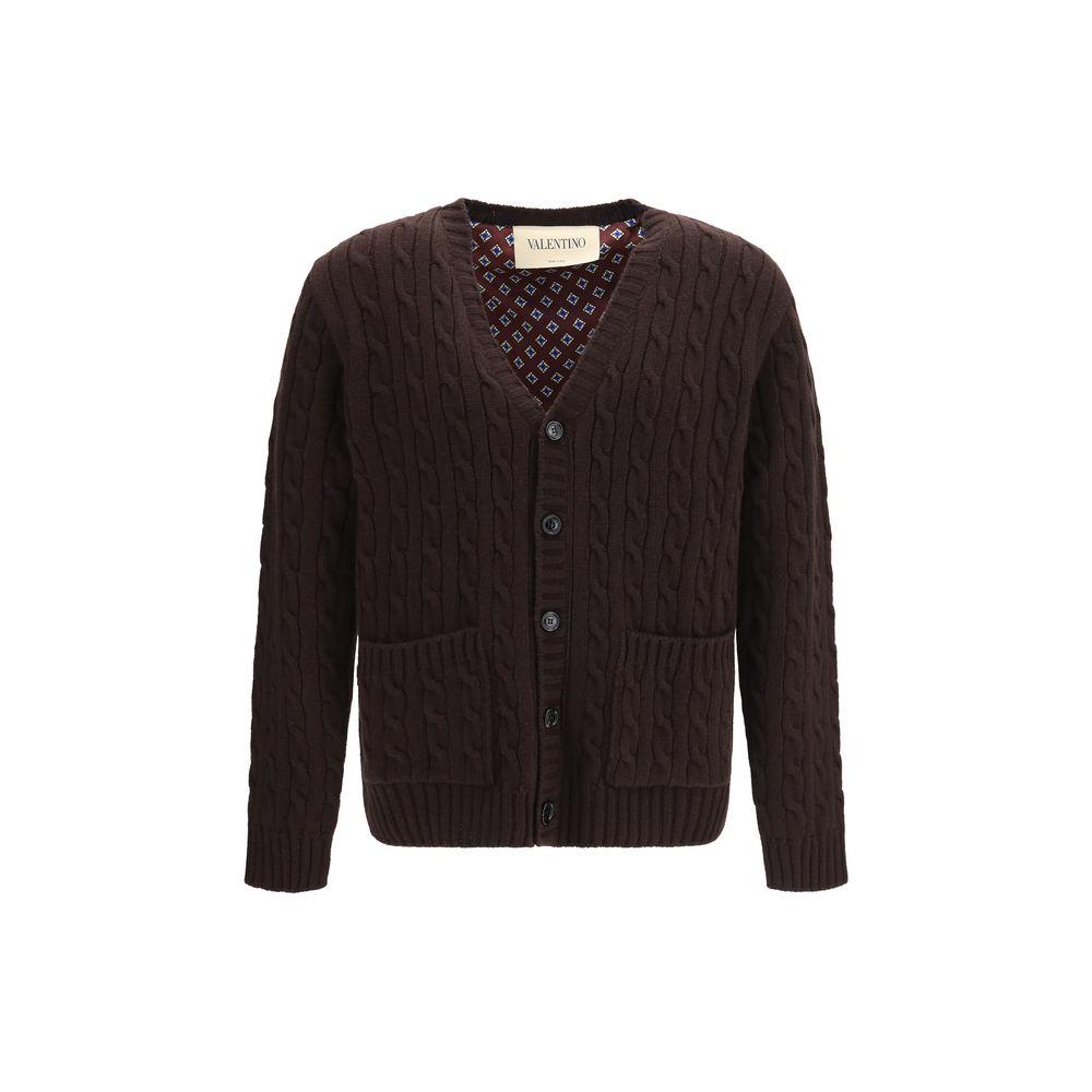 Indulge in the exquisite Valentino Garavani Brown Wool Oves Aries Cardigan, crafted from 100% Merino Wool, where timeless elegance meets unparalleled comfort for the discerning individual.