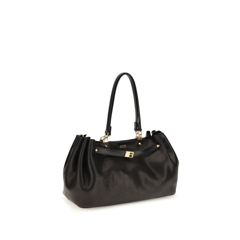 Indulge in the exquisite craftsmanship of the Balenciaga Black Calf Leather Bos Taurus Shoulder Bag, a timeless accessory that embodies luxury and sophistication for the discerning individual.