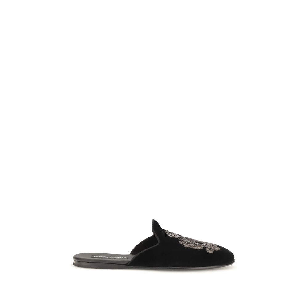Indulge in the exquisite craftsmanship of Dolce & Gabbana's Black Velvet Flats, where luxurious velvet meets refined elegance, embodying timeless sophistication for the discerning individual.