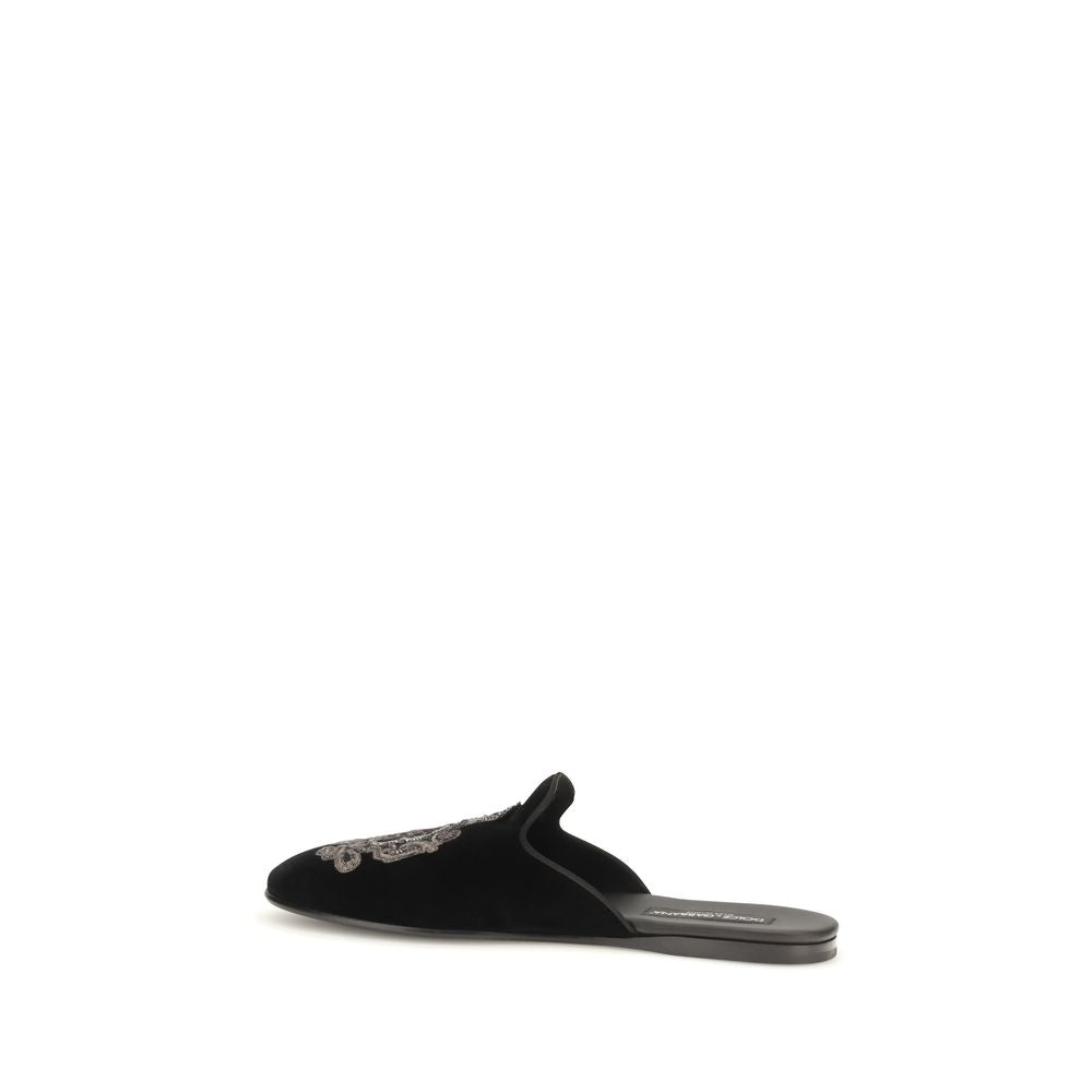 Indulge in the refined elegance of Dolce & Gabbana's Black Velvet Flats from the Young Pope line, crafted in Italy with exquisite double velvet and a distinguished crest.