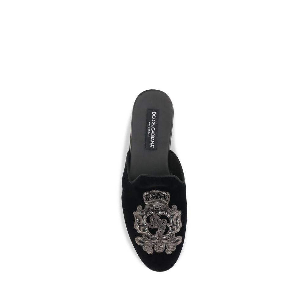Indulge in the exquisite craftsmanship of Dolce & Gabbana's Black Velvet Flats from the Young Pope collection, where luxurious velvet meets timeless elegance for the discerning connoisseur.