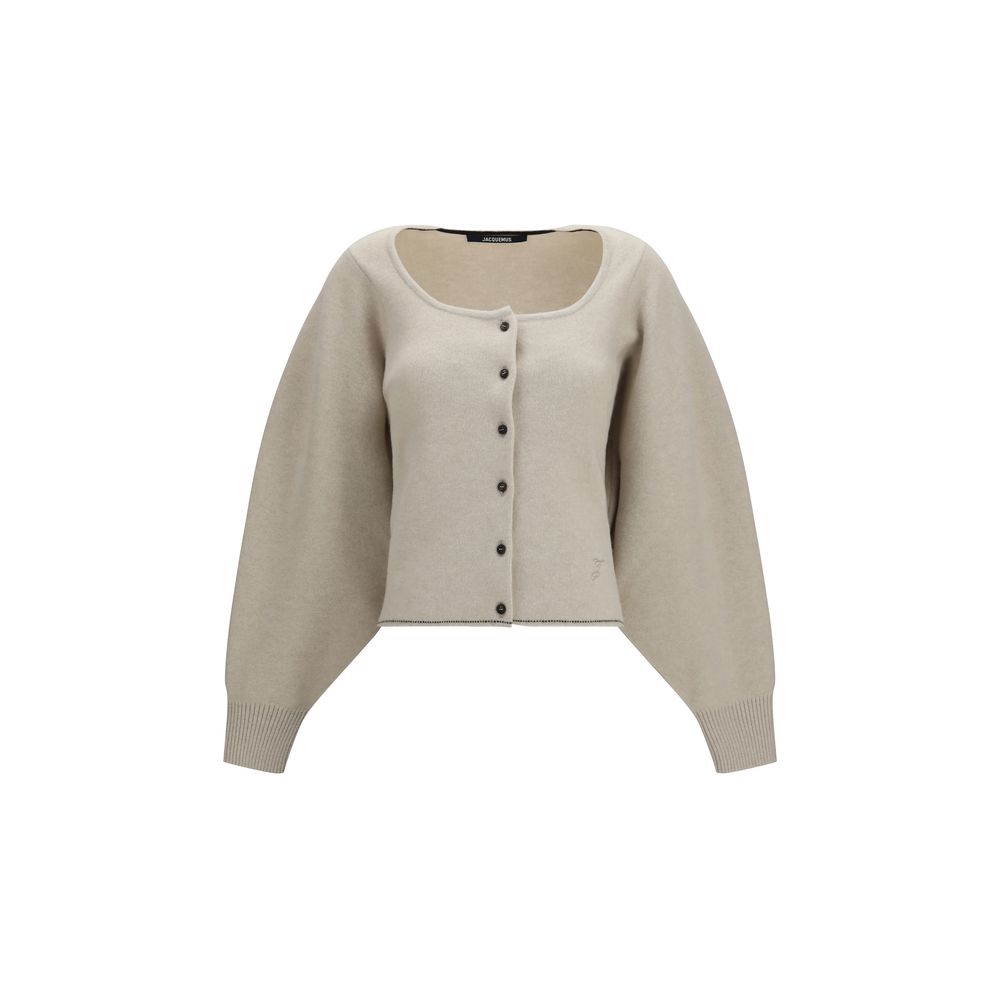 Indulge in the elegance of the Jacquemus Beige Wool Oves Aries Cardigan, a luxurious blend of wool and cashmere, embodying timeless sophistication and effortless allure.