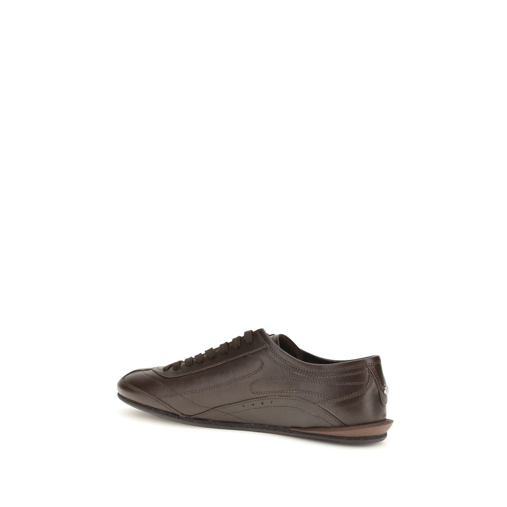 Indulge in the exquisite craftsmanship of Dolce & Gabbana's Brown Calf Leather Bos Taurus Low Top Sneakers, where luxury meets refined elegance for the discerning individual.