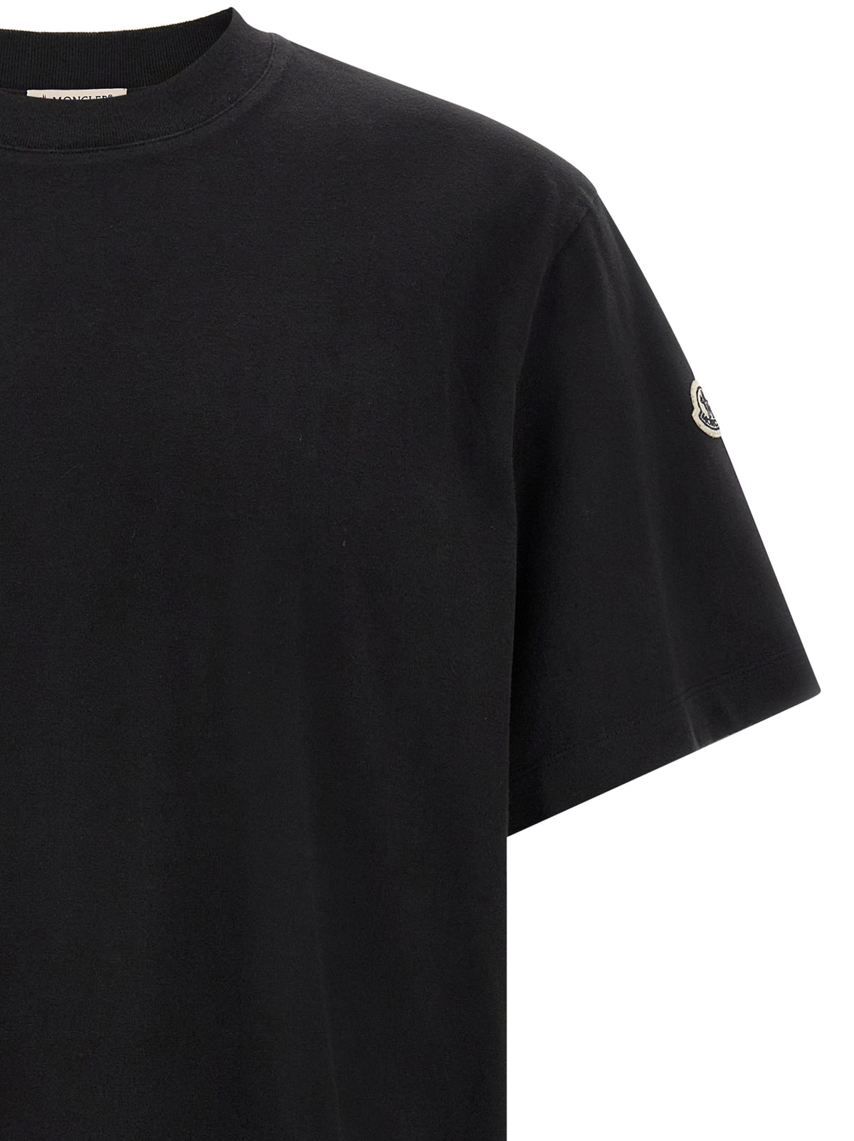 Elevate your wardrobe with the Moncler Genius Black Cotton T-Shirt, a masterpiece of urban sophistication crafted from luxurious cotton for unparalleled comfort and style.