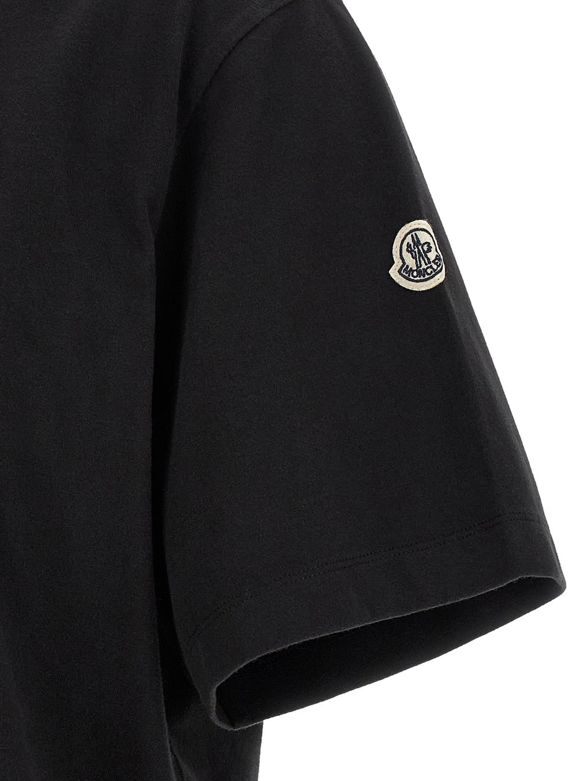 Elevate your wardrobe with the Moncler Genius Black Cotton T-Shirt, a luxurious blend of comfort and style, perfect for the discerning individual who values urban sophistication.