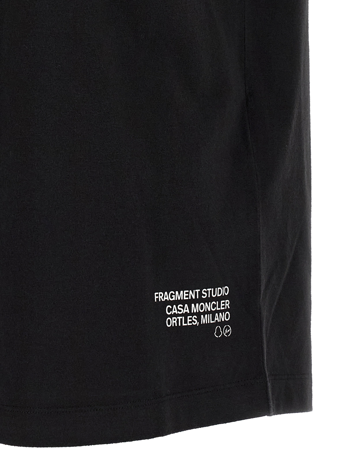 Elevate your wardrobe with the Moncler Genius Black Cotton T-Shirt, a masterpiece of urban sophistication crafted from luxurious cotton for unparalleled comfort and style.