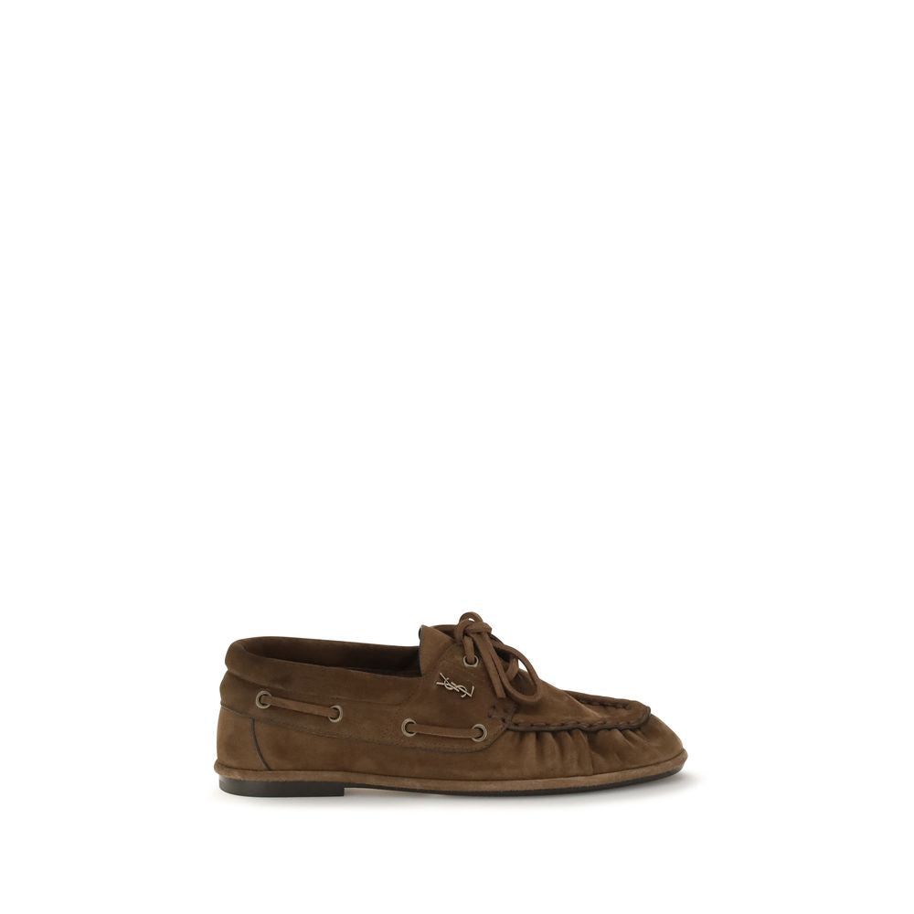 Experience the allure of Saint Laurent Brown Suede Leather Slip-On Loafers, crafted from luxurious suede with exquisite hand-stitched detailing, perfect for the discerning individual.