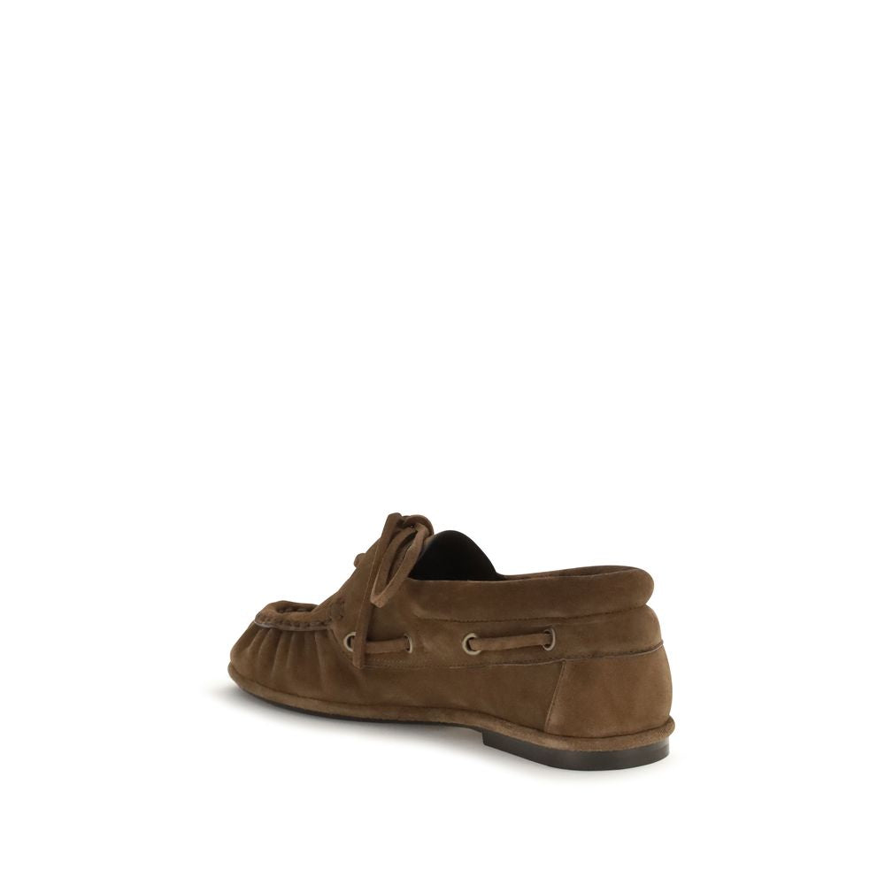Discover the Saint Laurent Brown Suede Leather Slip-On Loafers, where artisanal craftsmanship meets luxurious comfort, perfect for the discerning individual.
