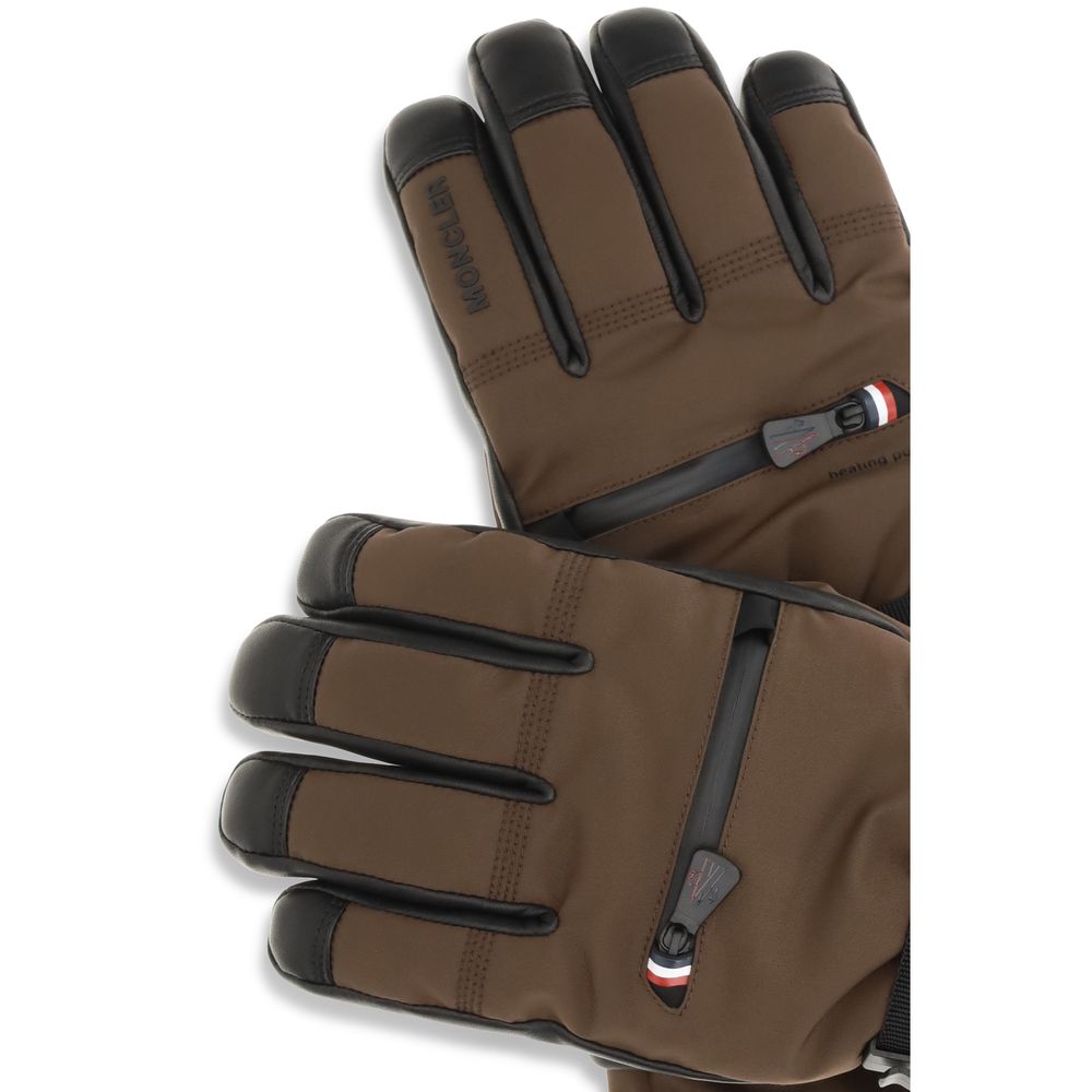 Indulge in the Moncler Grenoble Brown Nylon Gloves, where luxurious stretch nylon meets refined leather piping, offering warmth and sophistication for the discerning individual.