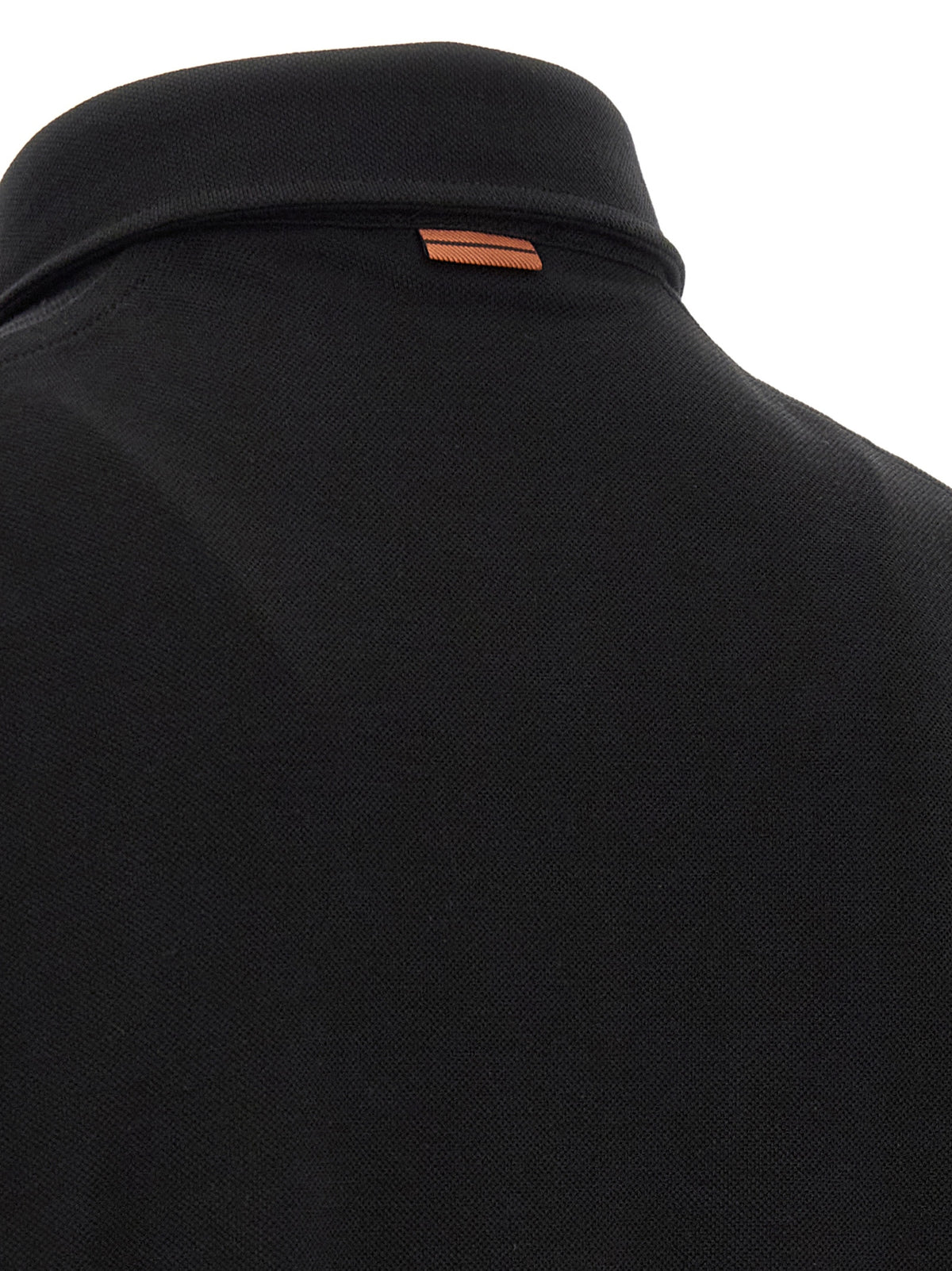 Discover the ZEGNA Black Cotton Polo Shirt, a masterpiece of modern elegance crafted from pure cotton, embodying sophistication and timeless style for the discerning individual.
