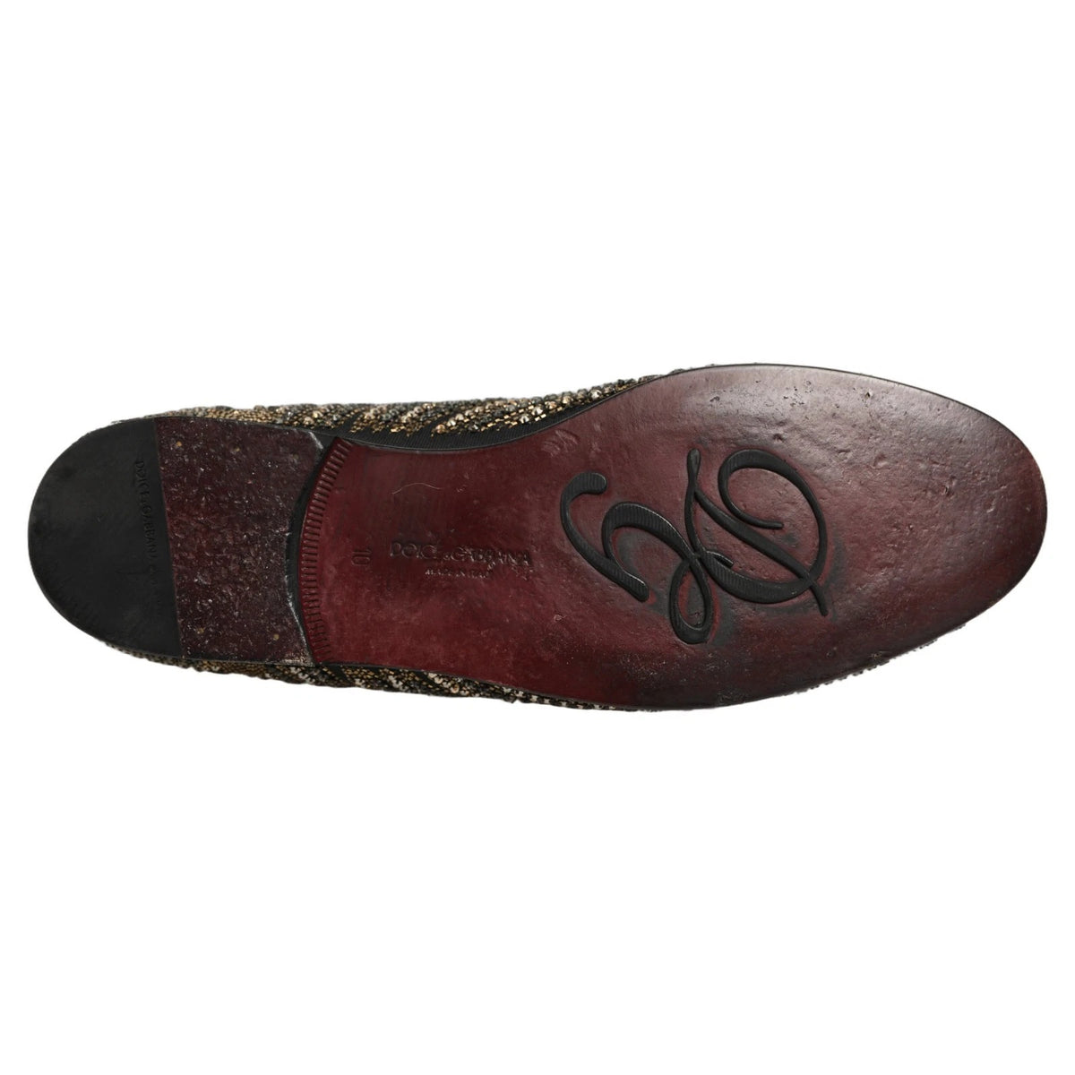 Indulge in the exquisite Dolce & Gabbana Black Gold Embellished Slippers, where luxurious leather meets intricate rhinestone artistry, epitomizing Italian craftsmanship and elegance.