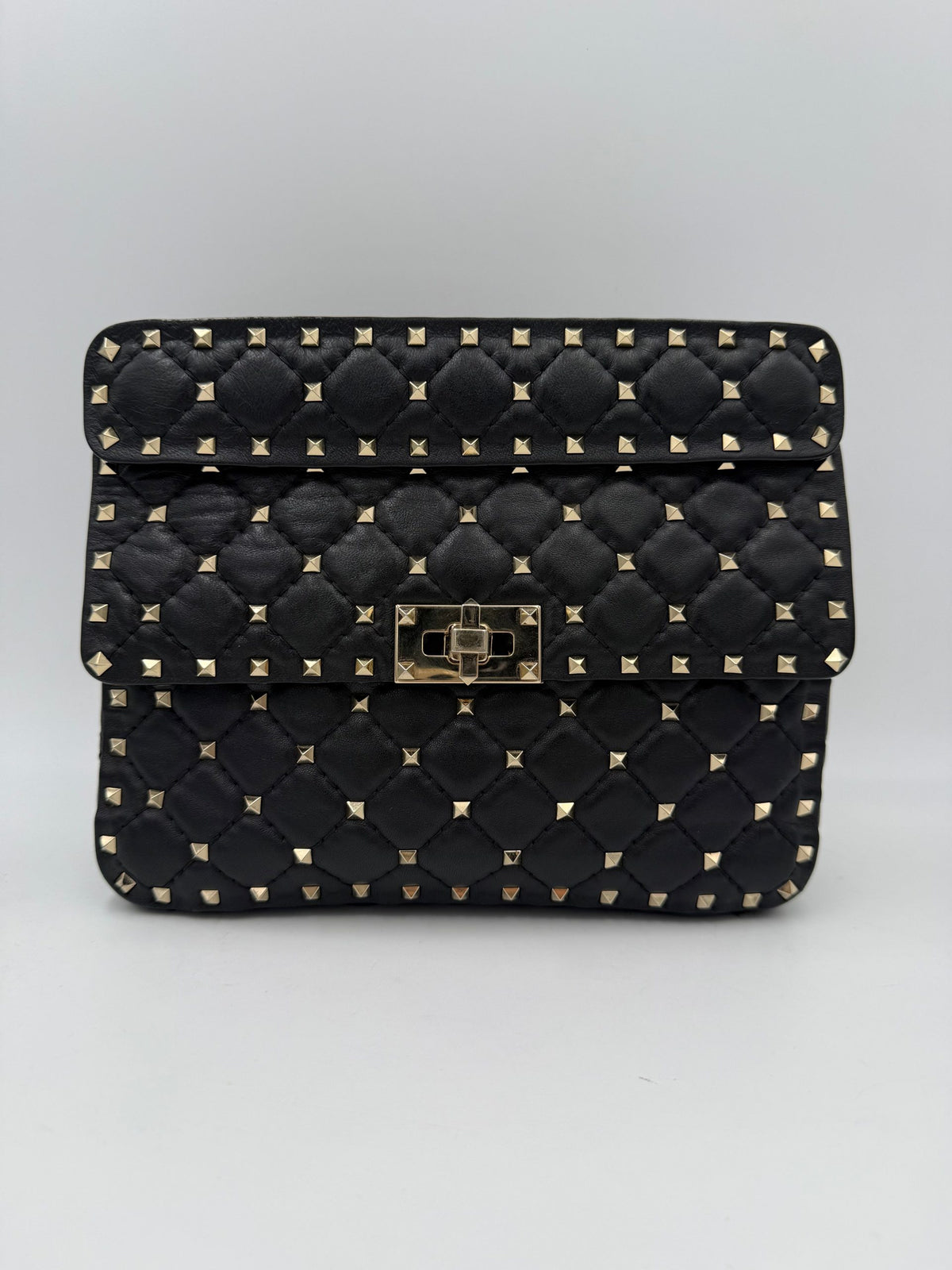 Indulge in the elegance of the Valentino Garavani Rockstud Spike Black Handbag, where soft leather meets exquisite silver-tone studs, embodying timeless luxury and modern allure.