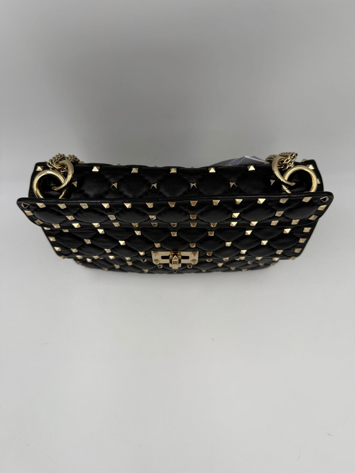 Indulge in the elegance of the Valentino Garavani Rockstud Spike Black Handbag, where soft leather meets exquisite silver-tone studs, embodying timeless luxury and sophistication.