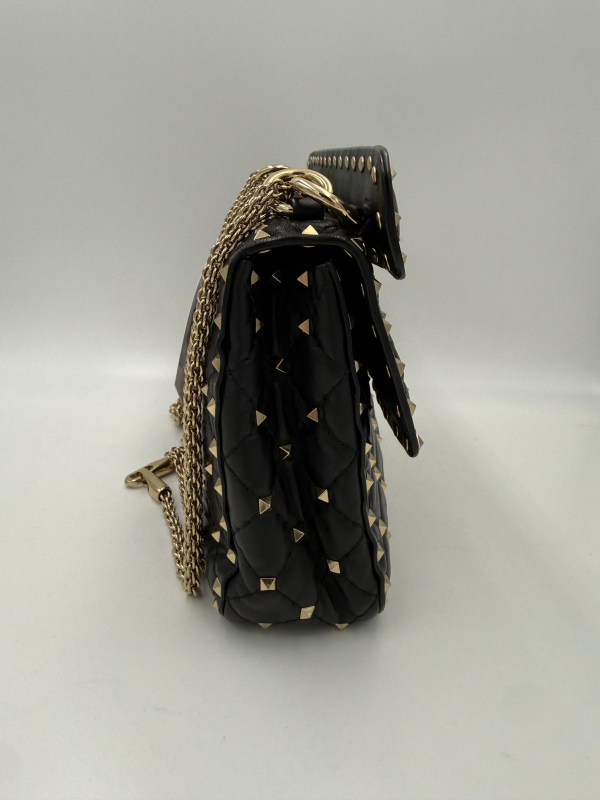 Indulge in the elegance of the Valentino Garavani Rockstud Spike Black Handbag, where soft leather meets exquisite craftsmanship, embodying timeless luxury and modern allure.