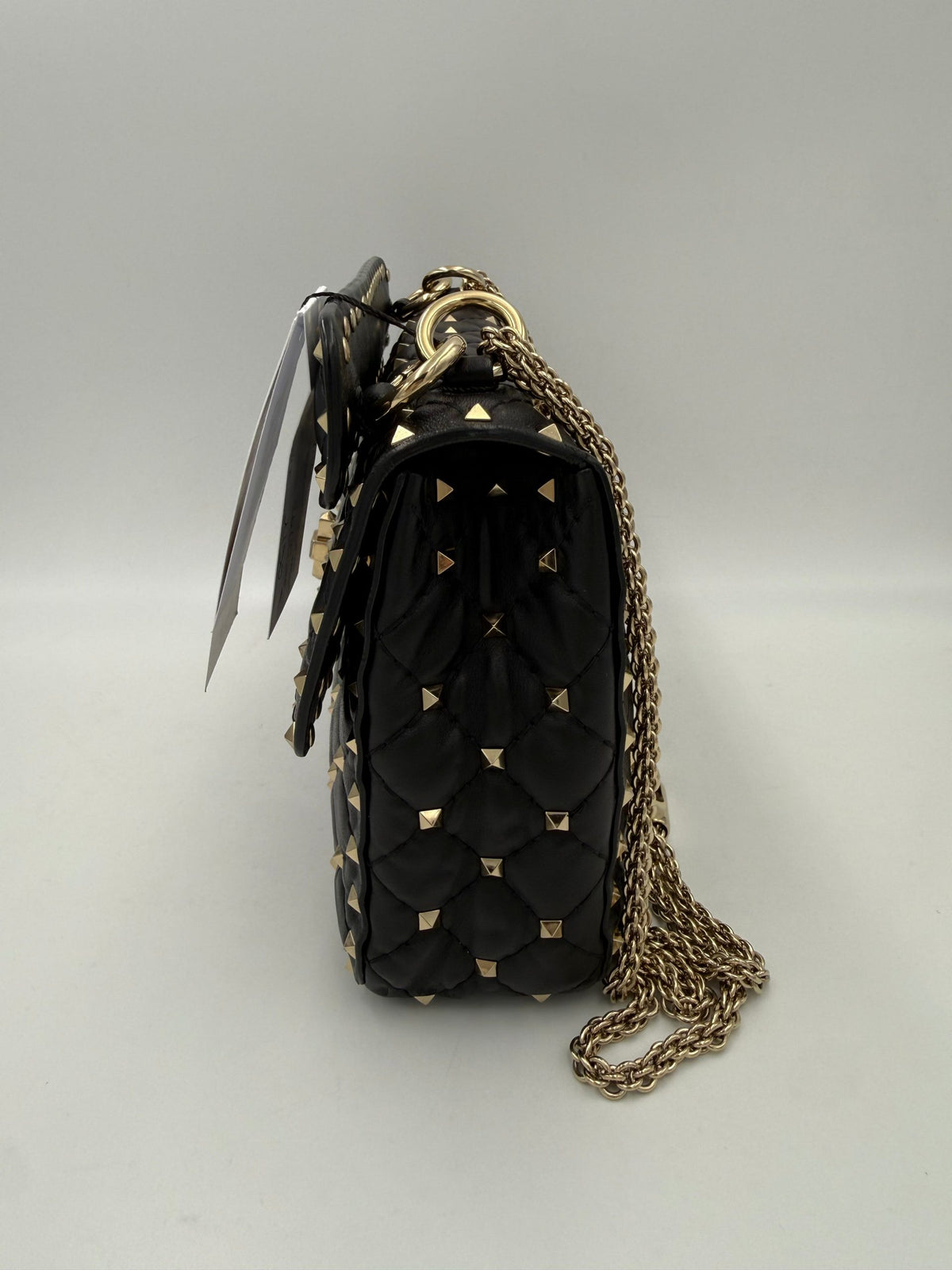 Indulge in the elegance of the Valentino Garavani Rockstud Spike Black Handbag, a masterpiece of Italian craftsmanship that embodies luxury and timeless allure.