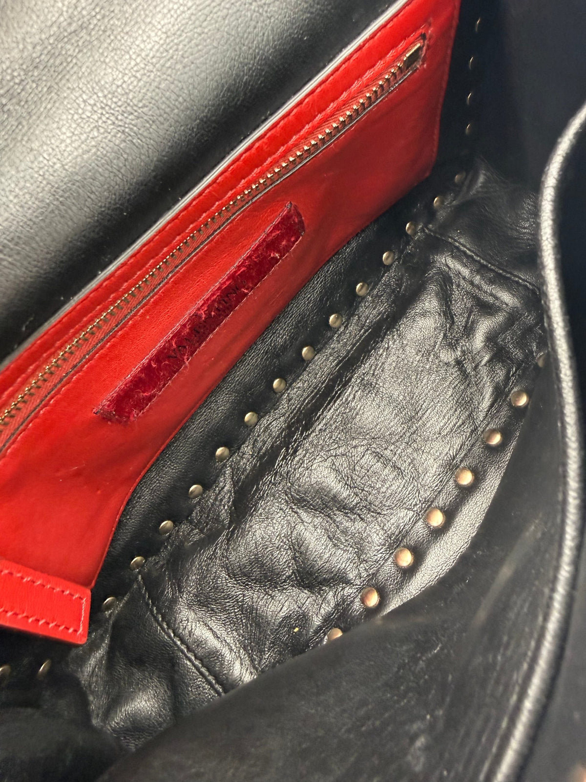 Indulge in the elegance of the Valentino Garavani Rockstud Spike Black Handbag, where soft leather meets exquisite craftsmanship, embodying timeless luxury and modern allure.