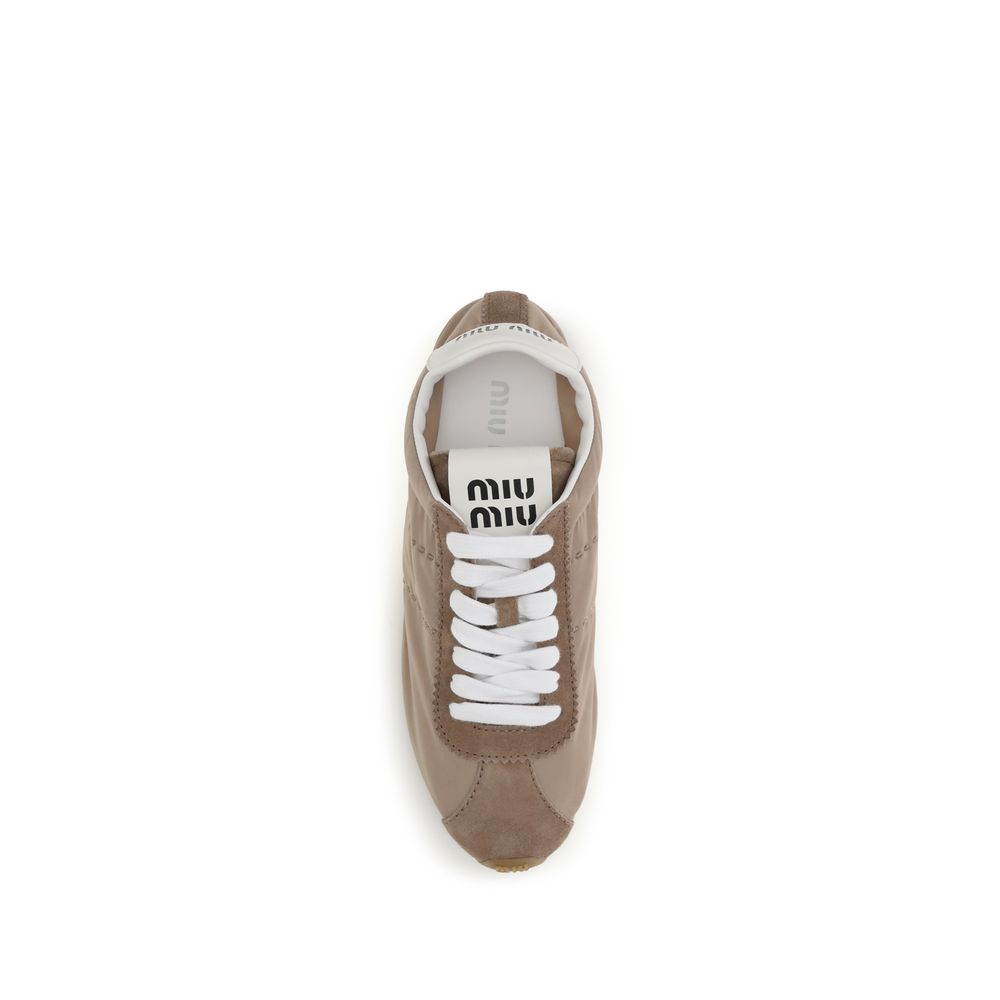 Elevate your style with Miu Miu's Beige Calf Leather Bos Taurus Low Top Sneakers, a perfect blend of sophistication and comfort for the discerning individual.