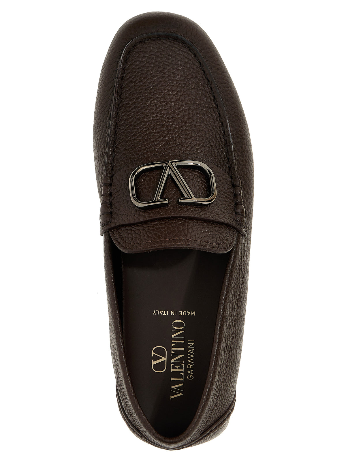 Step into a realm of elegance with Valentino Garavani's Brown Calfskin Slip-On Loafers, crafted in Italy from luxurious calf leather, embodying timeless sophistication and modern allure.