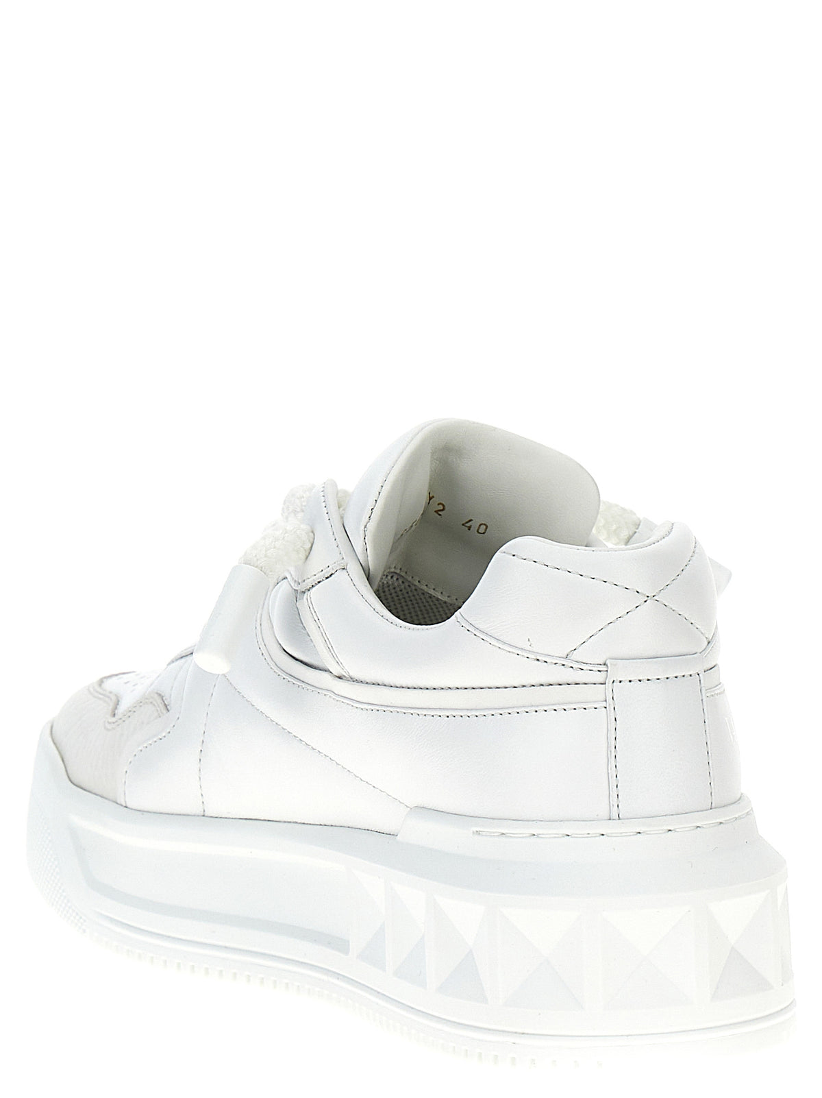 Indulge in the allure of Valentino Garavani's White Lamb Leather Low Top Sneakers, where exquisite craftsmanship meets bold sophistication for the discerning connoisseur.