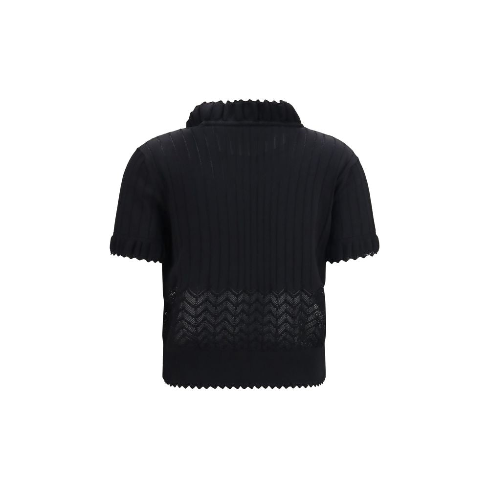 Indulge in the exquisite Alexander McQueen Black Viscose T-Shirt, a luxurious blend of 65% viscose and 35% polyamide, redefining elegance with its ruffled high neck and delicate lace insert.