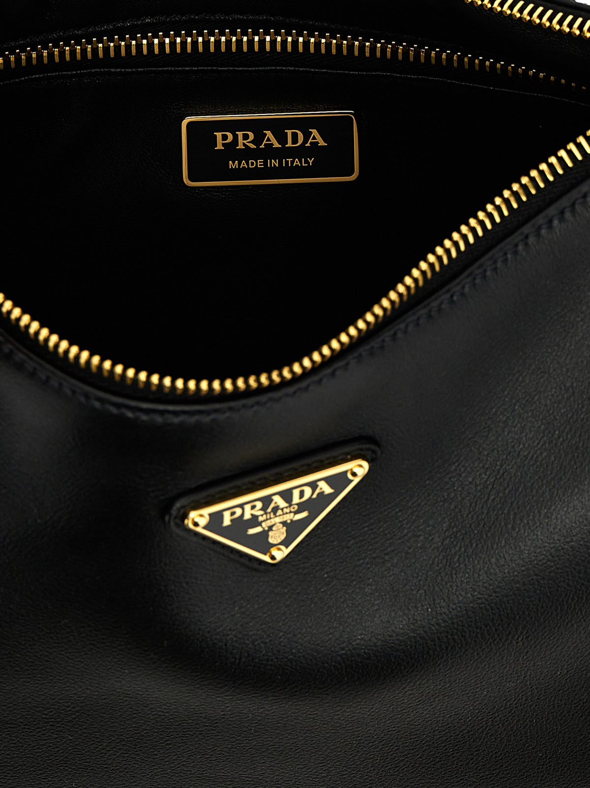 Indulge in the elegance of the Prada Aimée Medium leather shoulder bag, crafted from exquisite calfskin, embodying luxury and sophistication for the discerning individual.