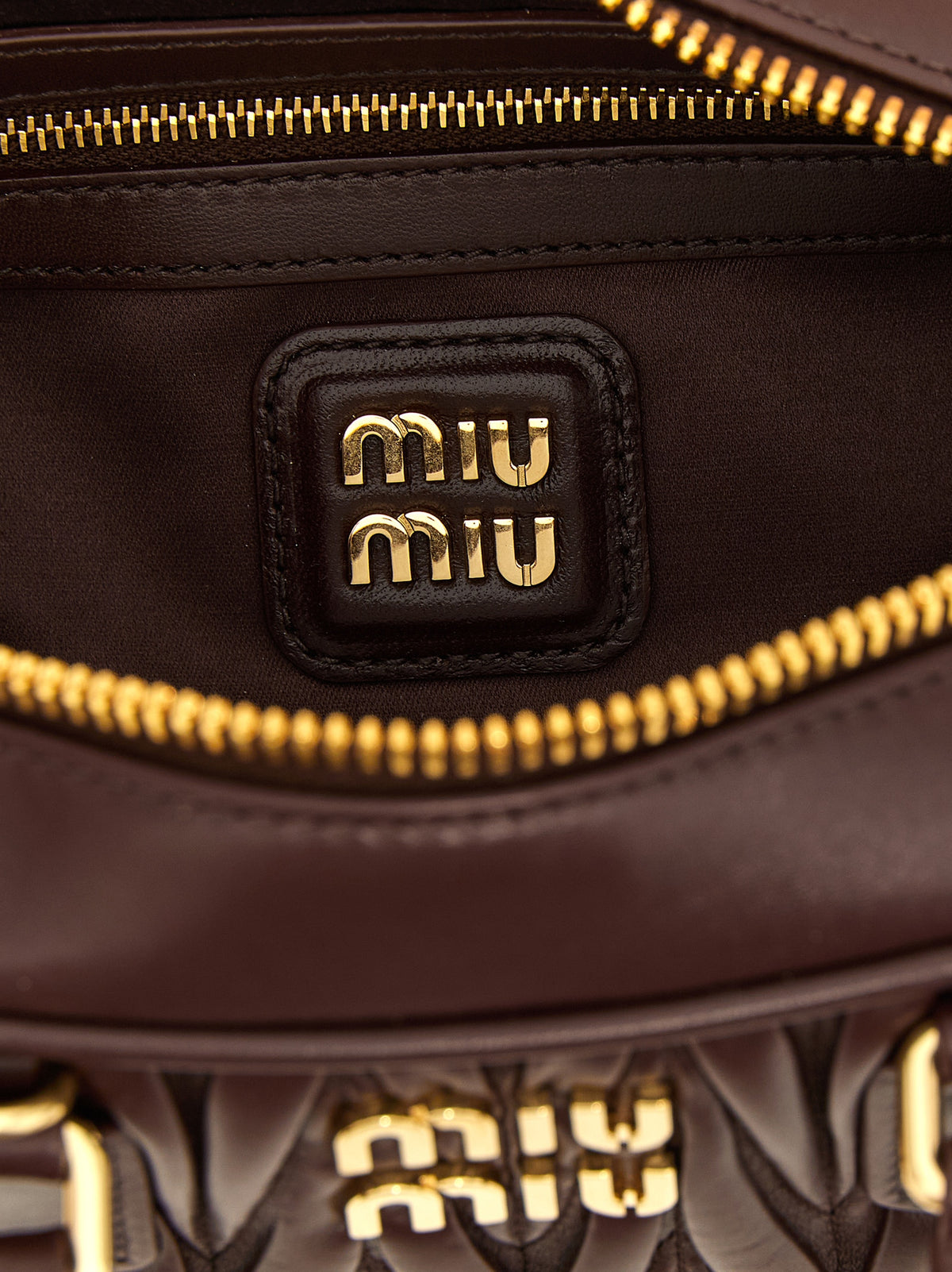 Indulge in the exquisite MIU MIU ‘Arcadie’ handbag, a masterpiece of matelassé lamb leather, embodying elegance and sophistication for the discerning individual.