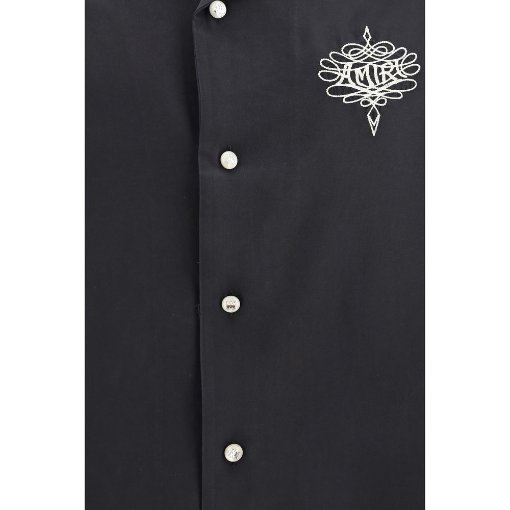 Discover the Amiri Black Modal Shirt, a masterpiece of oversized elegance crafted from luxurious modal and polyester, embodying sophistication for the discerning individual.