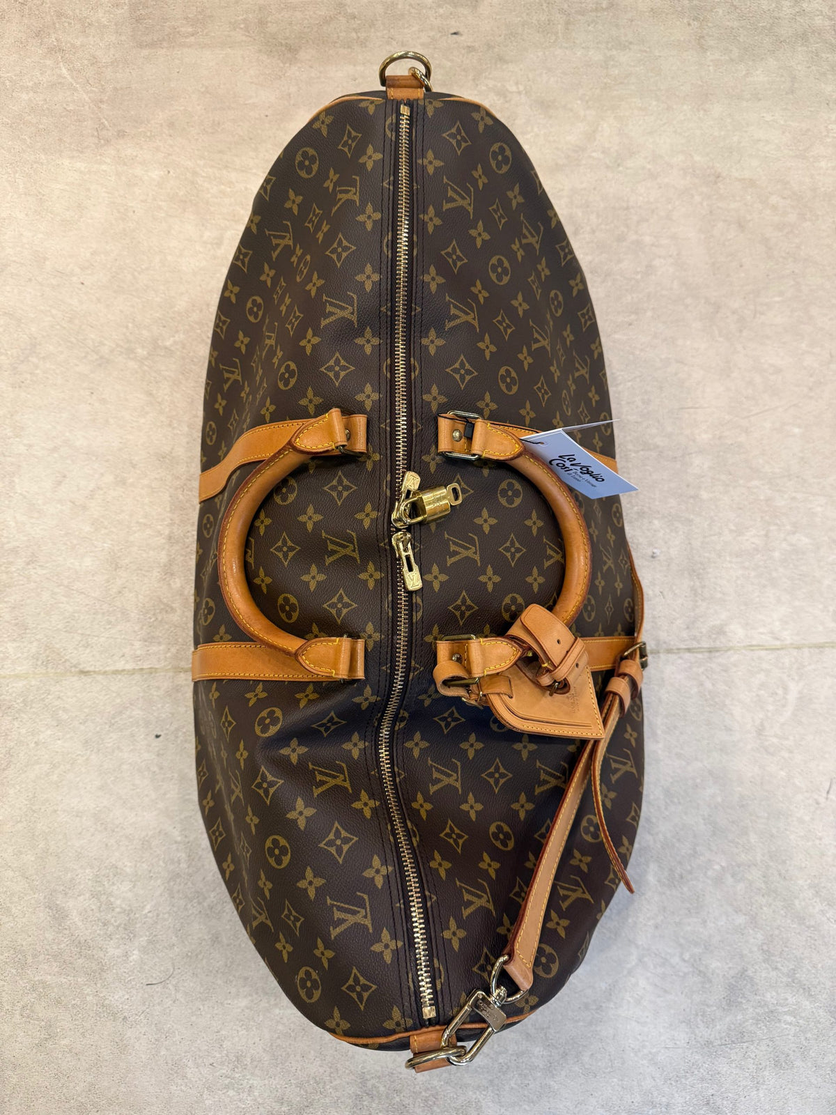 Discover the Louis Vuitton KEEPALL 60 Monogram, a timeless masterpiece that exudes luxury and versatility, perfect for the discerning connoisseur.