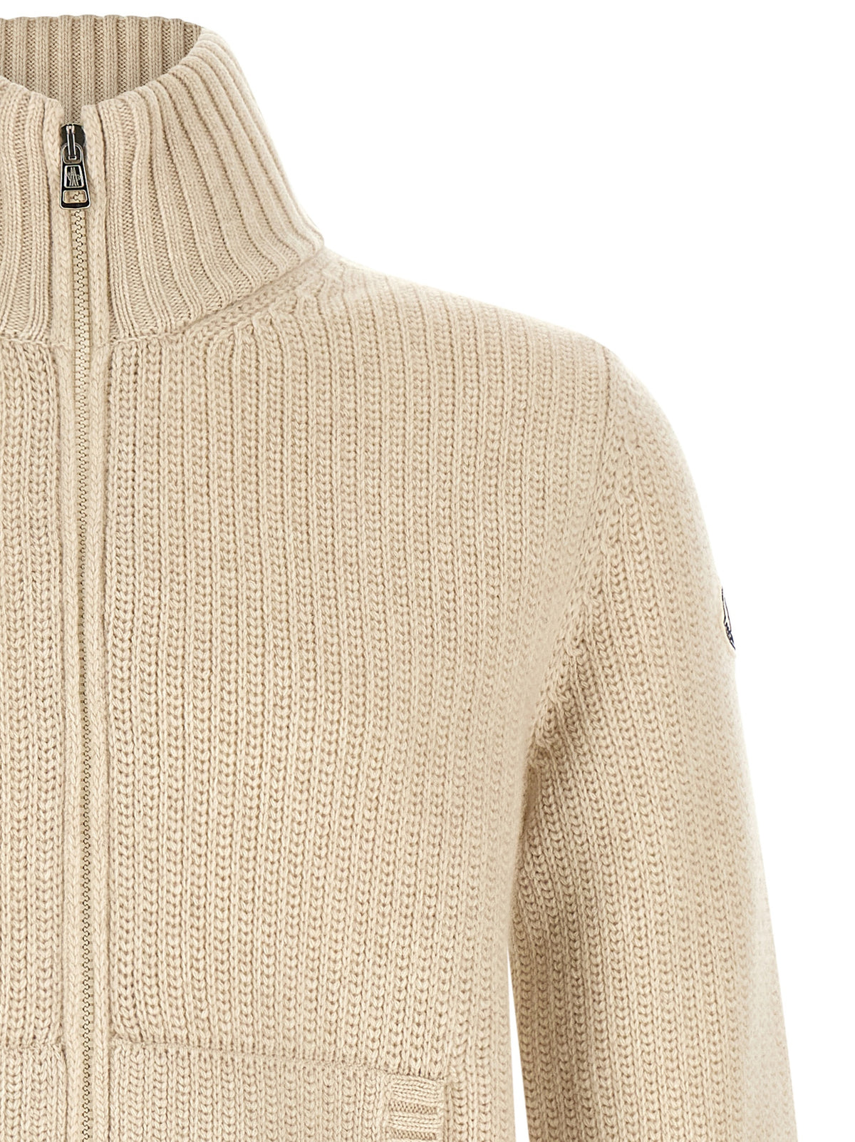 Indulge in the Moncler Beige Virgin Wool Cardigan, a luxurious blend of 90% virgin wool and 10% cashmere, epitomizing sophistication and timeless elegance for discerning tastes.