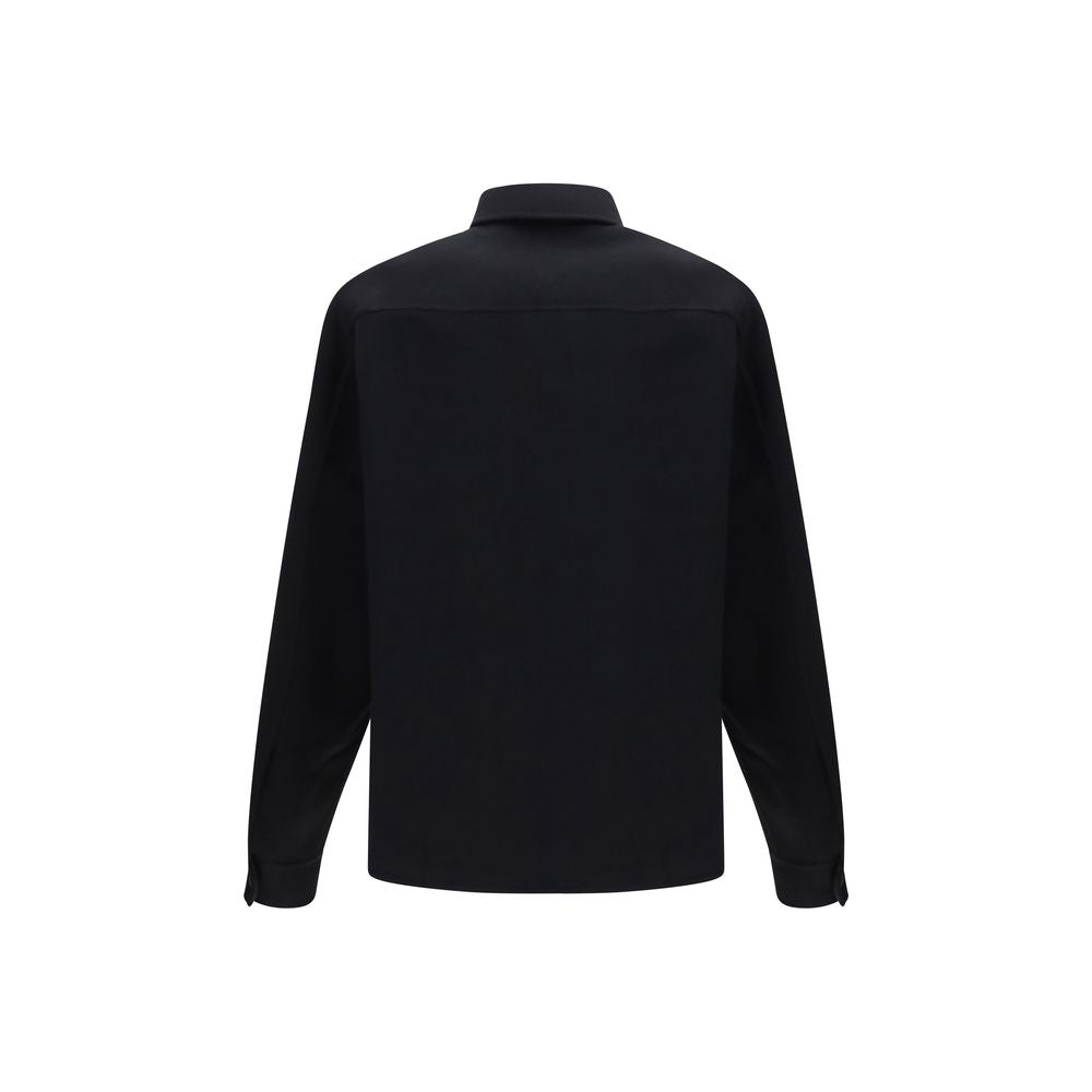 Indulge in the Fendi Black Wool Oves Aries Jacket, a masterpiece of double-faced virgin wool and silk, epitomizing refined Italian craftsmanship and timeless elegance.