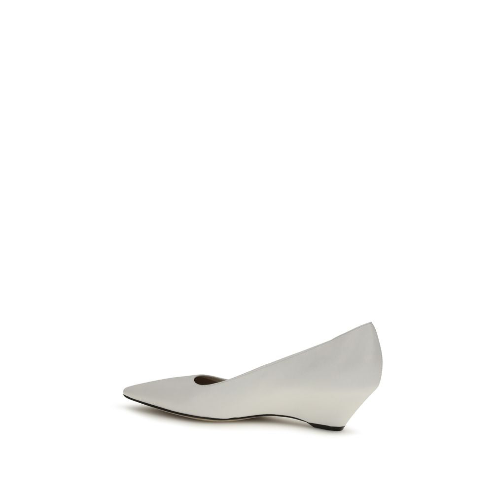 Indulge in the exquisite craftsmanship of The Row White Lamb Ovis Aries Platform Pumps, where luxurious lambskin meets a sophisticated silhouette, embodying timeless elegance.