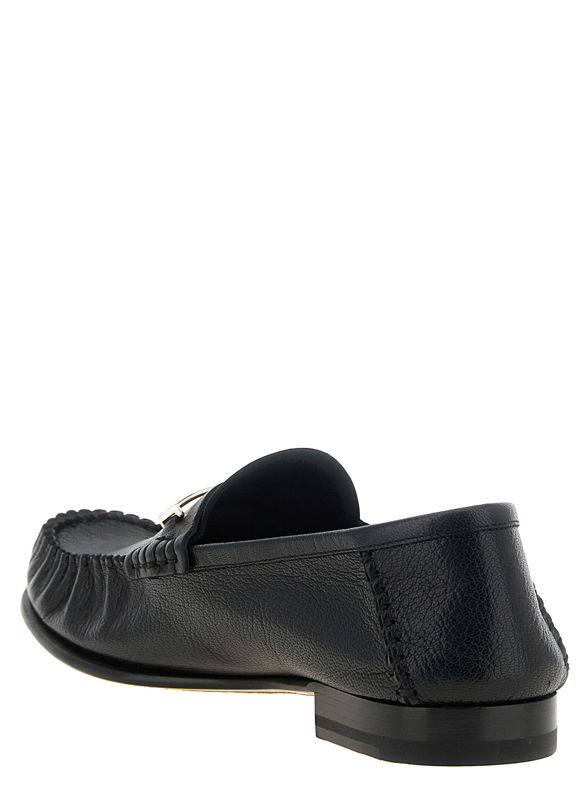 Step into timeless elegance with Tom Ford's Black Goatskin Slip-On Loafers, where exquisite craftsmanship meets luxurious comfort for the discerning individual.