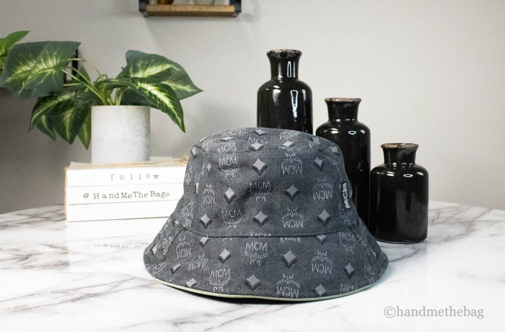 Elevate your style with the MCM Visetos Dark Grey Bucket Hat, a luxurious blend of recycled polyamide and cotton, embodying sophistication and timeless allure.