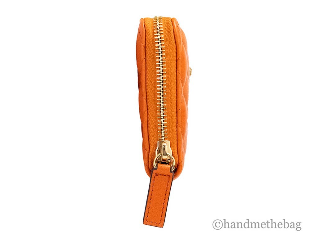 Indulge in the Versace Large Dark Orange Quilted Smooth Leather Continental Clutch, where exquisite craftsmanship meets vibrant elegance, perfect for any sophisticated occasion.