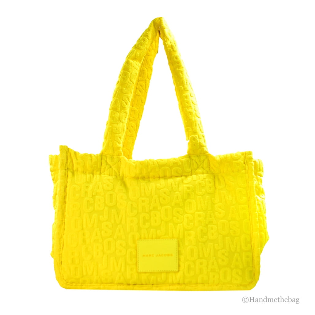 Elevate your style with the Marc Jacobs Medium The Terry Fabric Golden Kiwi Monogram Tote Bag, a luxurious blend of elegance and functionality for the discerning individual.