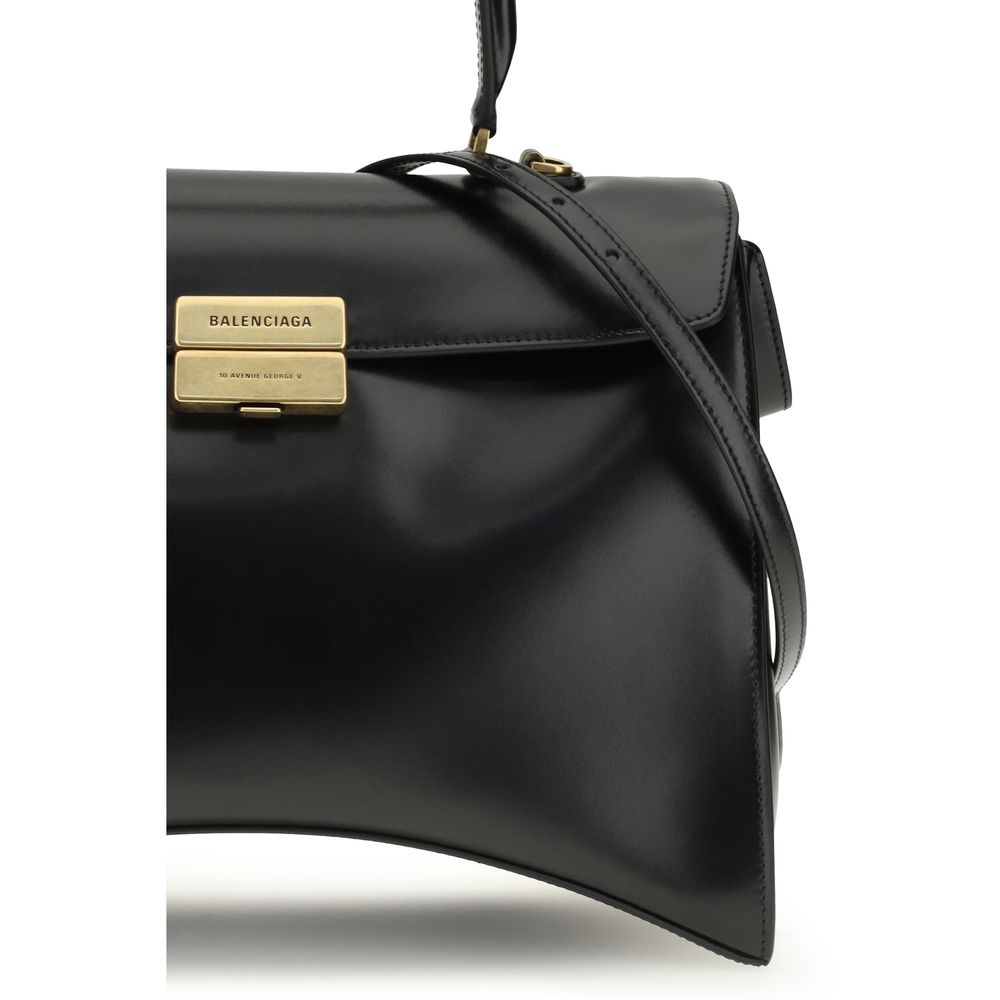 Discover the Balenciaga Black Calf Leather Bos Taurus Shoulder Bag, a sculptural masterpiece of glossy calfskin, embodying luxury and sophistication for the discerning individual.