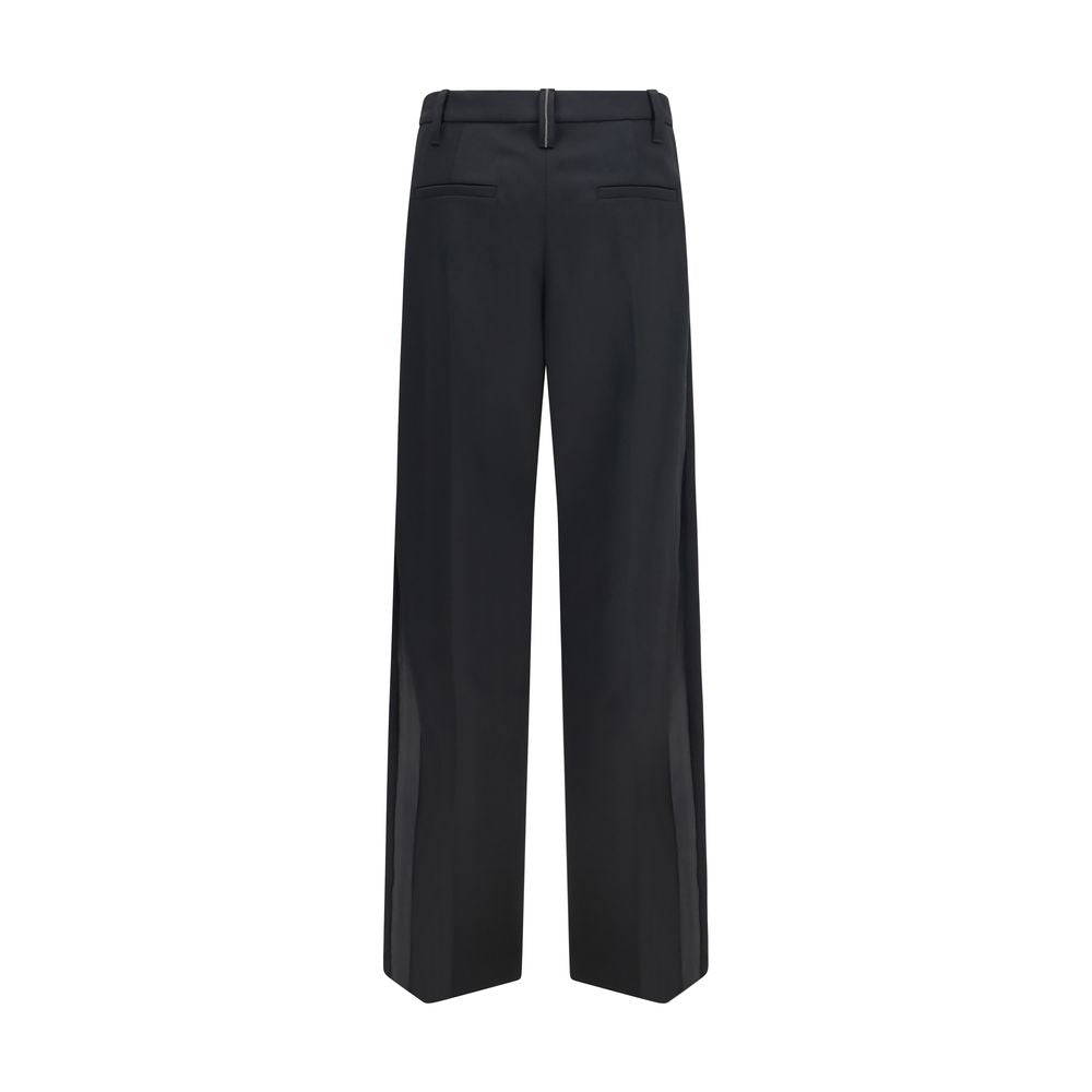 Indulge in the exquisite craftsmanship of Brunello Cucinelli's Black Wool Oves Aries Dress Pants, where luxury meets timeless elegance for the discerning individual.