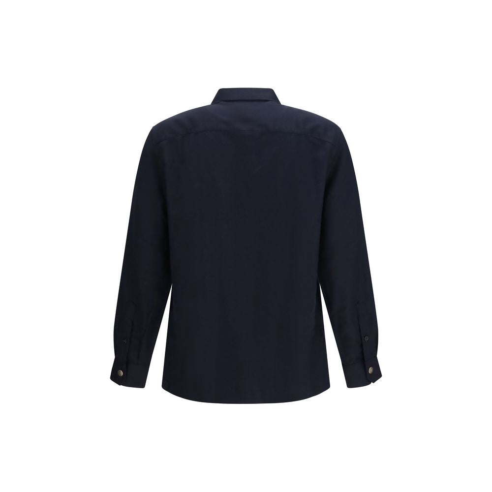 Elevate your wardrobe with the Brunello Cucinelli Blue Wool Oves Aries Shirt, where exquisite fleece wool craftsmanship meets timeless elegance for the discerning individual.
