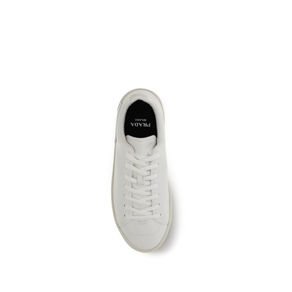 Indulge in the refined elegance of Prada's White Calf Leather Bos Taurus Low Top Sneakers, where impeccable craftsmanship meets contemporary luxury for the discerning individual.