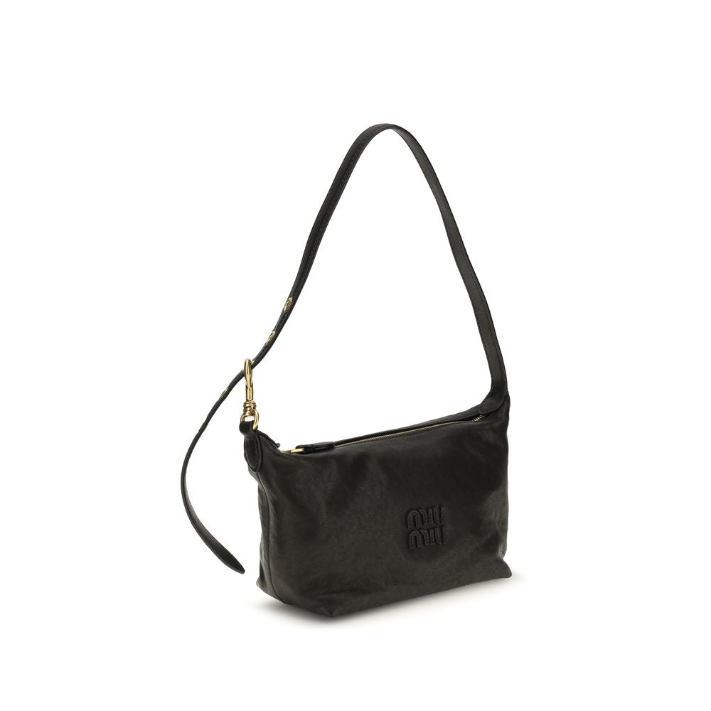 Indulge in the Miu Miu Black Suede Leather Shoulder Bag, a masterpiece of craftsmanship that exudes timeless elegance and sophistication for the discerning individual.