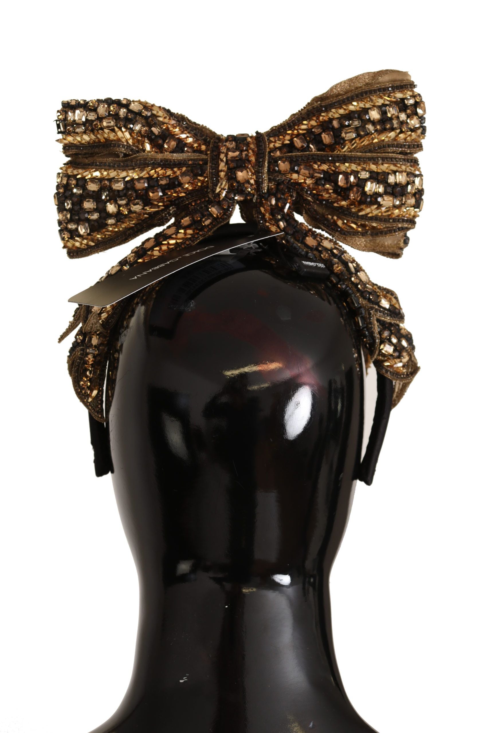 Indulge in the opulence of the Dolce & Gabbana Gold Crystal Beaded Silk Bow Headband, a handcrafted masterpiece that elevates any ensemble with its exquisite Italian craftsmanship and luxurious embellishments.