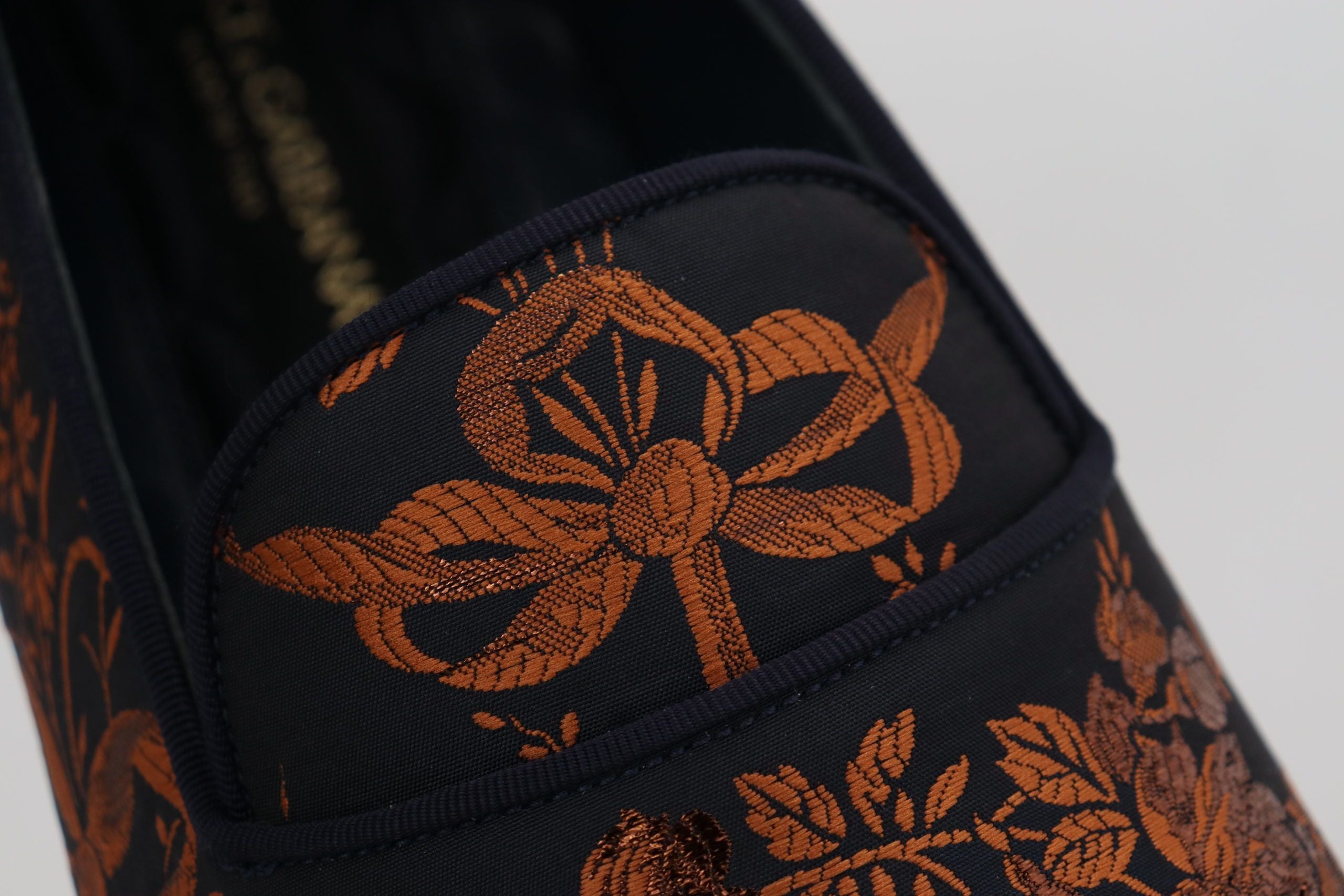 Elevate your elegance with Dolce & Gabbana's Blue Rust Floral Slippers, a luxurious blend of exquisite materials, crafted in Italy for the discerning individual.